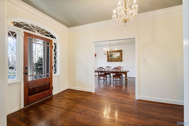 entrance foyer featuring ornamental molding, dark hardwood / wood-style flooring, and a chandelier