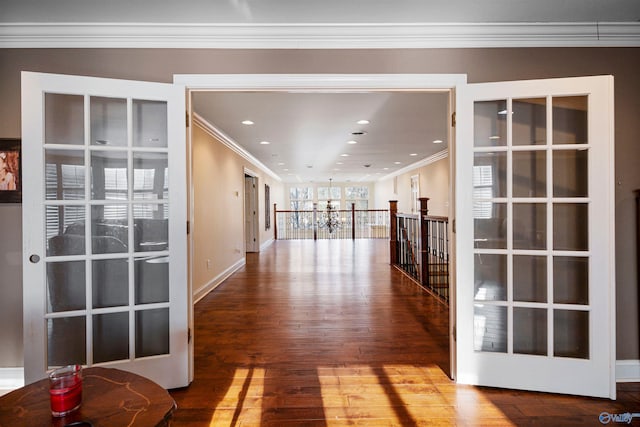 hall with hardwood / wood-style flooring and ornamental molding