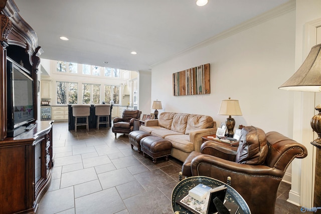 living room with dark tile patterned floors and crown molding