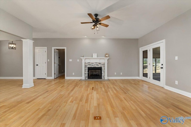 unfurnished living room with a fireplace, ceiling fan, and light hardwood / wood-style flooring