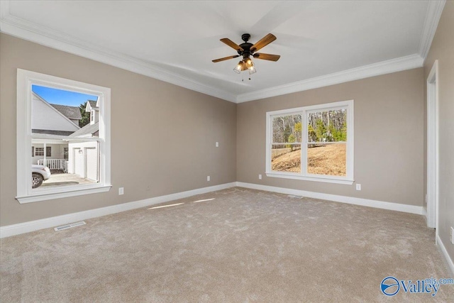 carpeted empty room featuring crown molding and ceiling fan