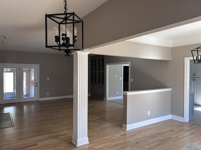 interior space with hardwood / wood-style floors, vaulted ceiling, and a chandelier