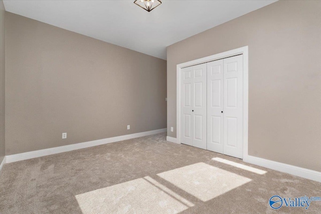 unfurnished bedroom featuring a closet and carpet flooring