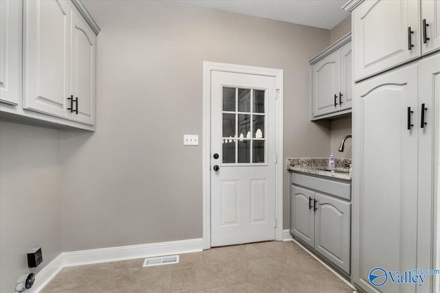 clothes washing area featuring sink