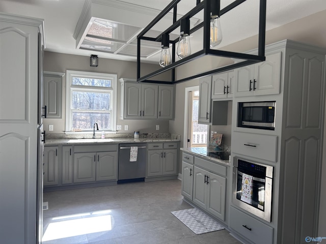 kitchen featuring a healthy amount of sunlight, stainless steel appliances, gray cabinets, and sink