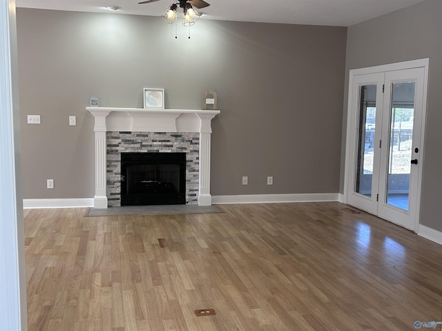 unfurnished living room featuring light hardwood / wood-style flooring, a fireplace, and ceiling fan