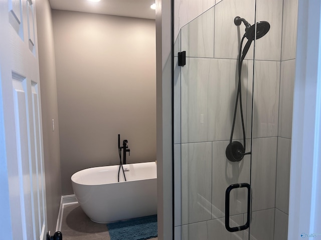 bathroom featuring separate shower and tub