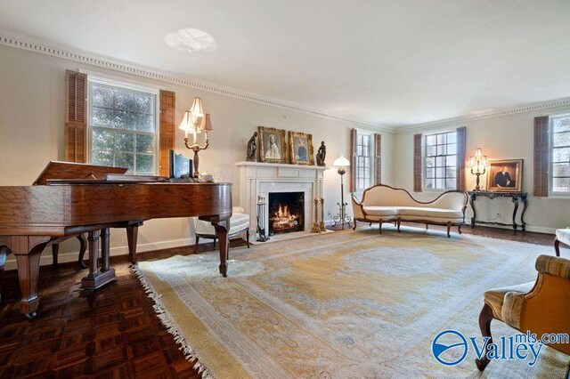 living room featuring parquet floors, ornamental molding, and plenty of natural light