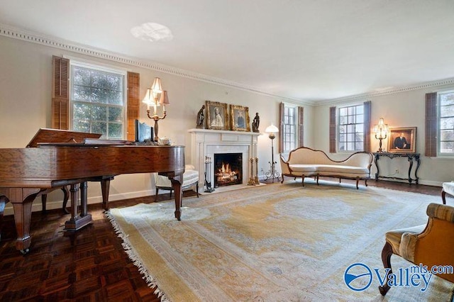 sitting room featuring a high end fireplace, baseboards, and ornamental molding