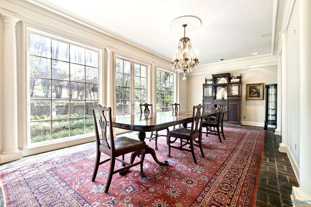 dining area with crown molding and a chandelier