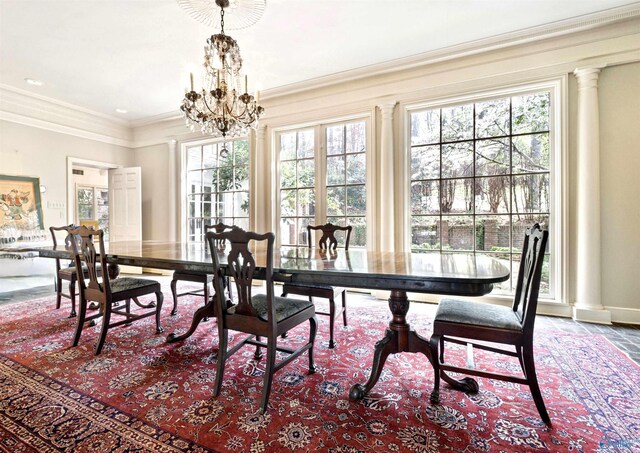 dining room featuring ornamental molding, decorative columns, and a chandelier