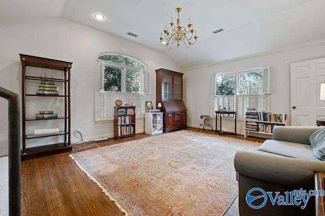 living area featuring wood finished floors, visible vents, plenty of natural light, vaulted ceiling, and a chandelier