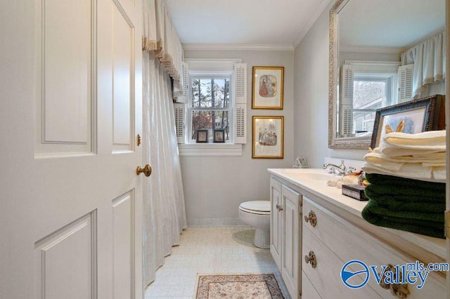 bathroom featuring vanity, crown molding, toilet, and a healthy amount of sunlight