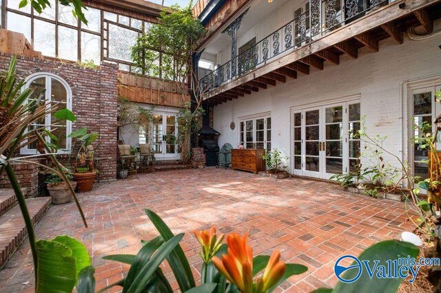 view of patio featuring a balcony and french doors