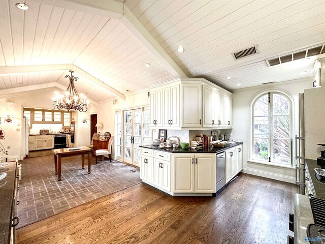 kitchen featuring vaulted ceiling with beams, appliances with stainless steel finishes, tasteful backsplash, pendant lighting, and a chandelier