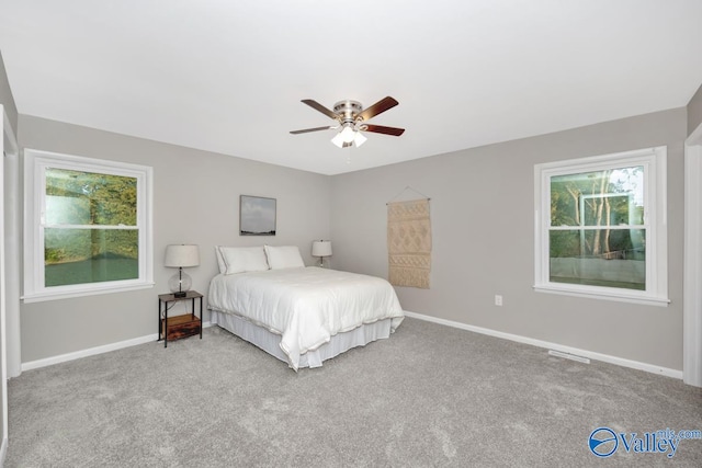 bedroom featuring light carpet and ceiling fan