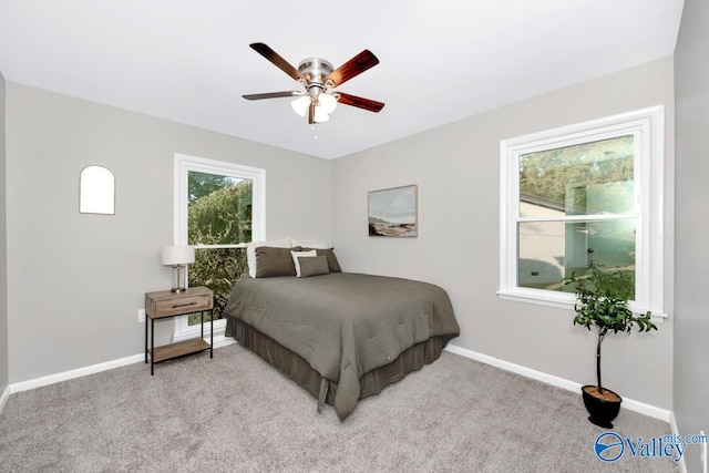 bedroom with ceiling fan and light colored carpet