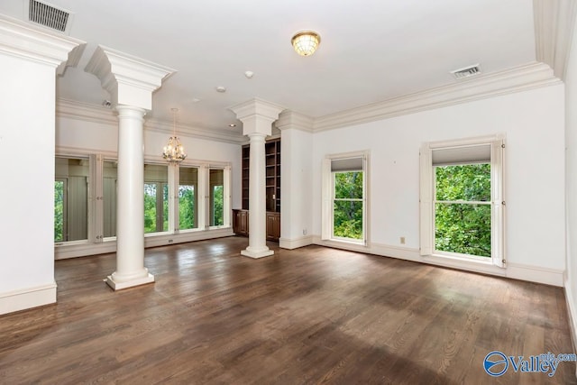 unfurnished living room with visible vents, baseboards, and decorative columns