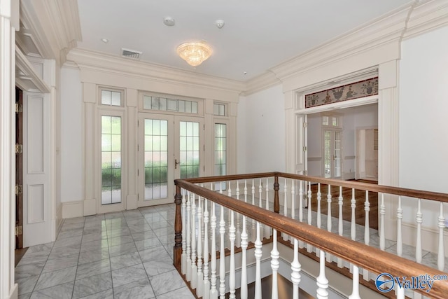 corridor with an upstairs landing, marble finish floor, visible vents, ornamental molding, and french doors