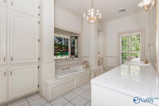 laundry room with crown molding, light tile patterned flooring, a sink, and a chandelier