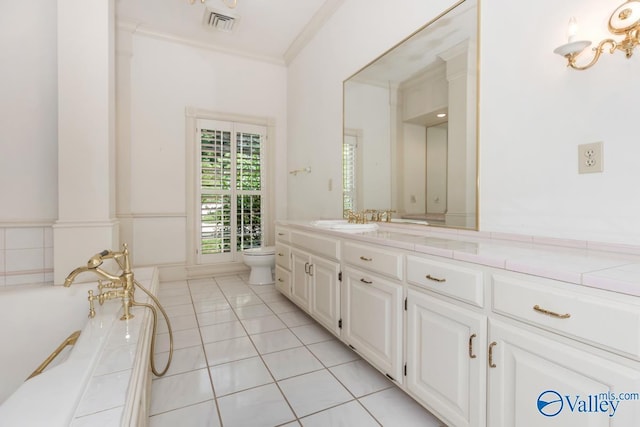 bathroom featuring vanity, tile patterned floors, toilet, crown molding, and a freestanding bath