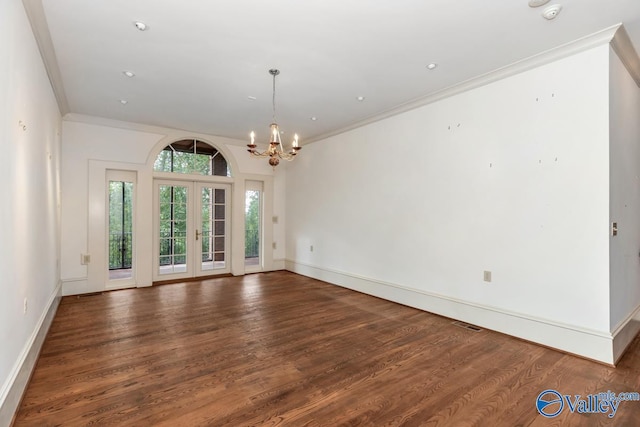 interior space featuring an inviting chandelier, wood finished floors, french doors, and ornamental molding