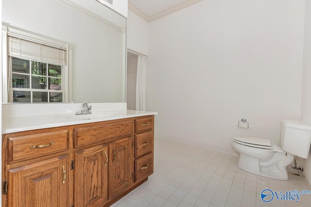 bathroom with toilet, tile patterned flooring, crown molding, and vanity
