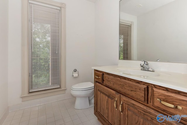 bathroom featuring vanity, toilet, and tile patterned flooring