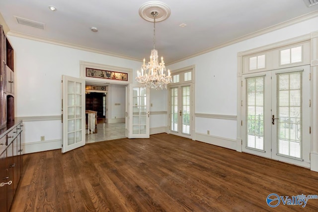 unfurnished dining area with a chandelier, crown molding, visible vents, french doors, and dark wood finished floors