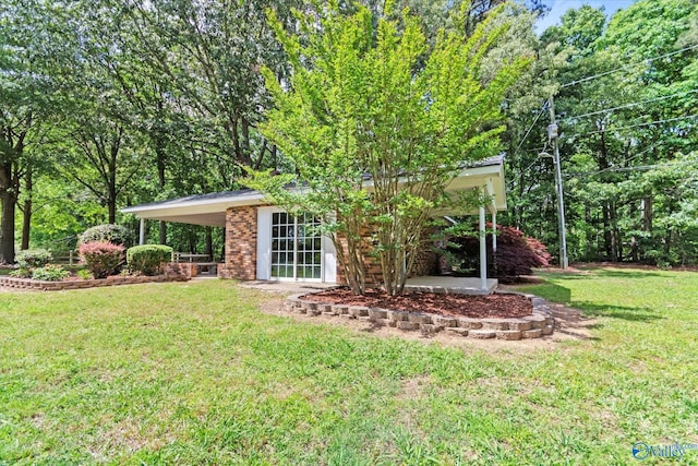 1025 Berkley Rd, Arab, AL 35016 - view of green lawn with a carport
