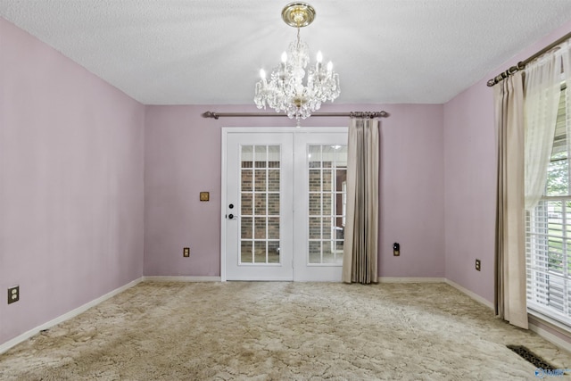 1025 Berkley Rd, Arab, AL 35016 - carpeted empty room with a chandelier, a textured ceiling, and baseboards