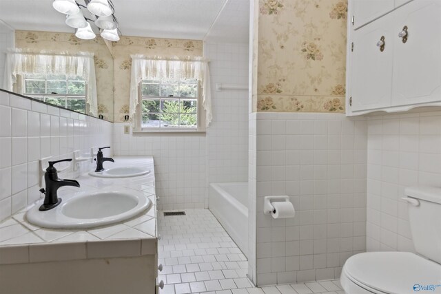 1025 Berkley Rd, Arab, AL 35016 - bathroom featuring wallpapered walls, toilet, tile walls, wainscoting, and a chandelier