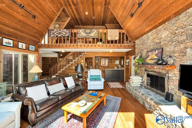 living room with track lighting, wood ceiling, and high vaulted ceiling