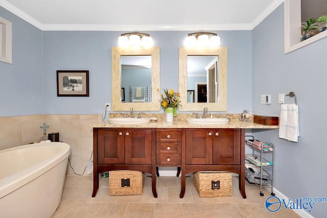 bathroom with dual vanity, ornamental molding, a bath, and tile patterned floors