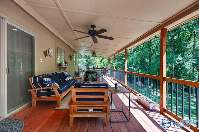 wooden terrace with ceiling fan and outdoor lounge area