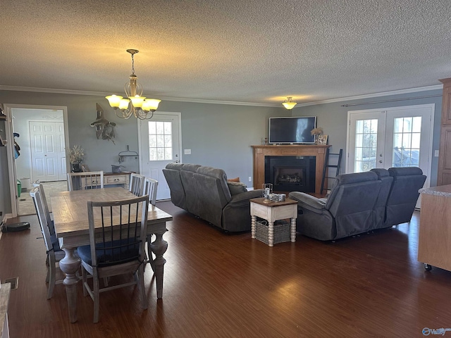 2415 Ruth Rd, Arab, AL 35016 - dining space featuring plenty of natural light, an inviting chandelier, dark wood finished floors, and crown molding