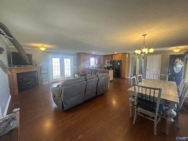 2415 Ruth Rd, Arab, AL 35016 - living area featuring a fireplace, a textured ceiling, dark wood-type flooring, and an inviting chandelier