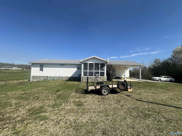 2415 Ruth Rd, Arab, AL 35016 - view of front of house featuring a carport, a front yard, and a sunroom