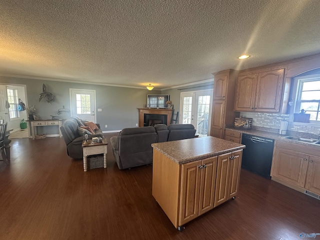 2415 Ruth Rd, Arab, AL 35016 - kitchen with ornamental molding, a kitchen island, black dishwasher, dark wood finished floors, and a fireplace