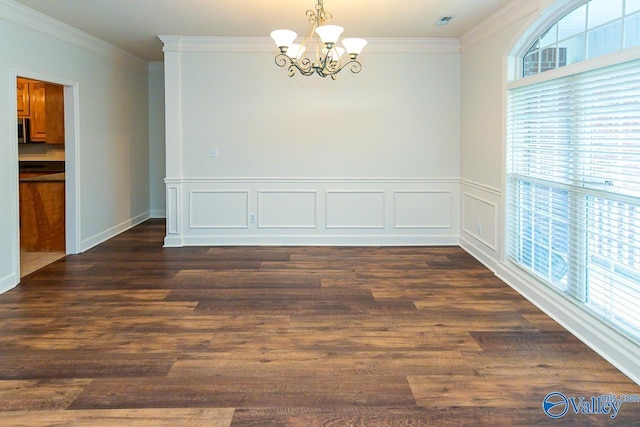 300 Honor Way, Madison, AL 35758 - spare room with a chandelier, ornamental molding, and dark wood-type flooring