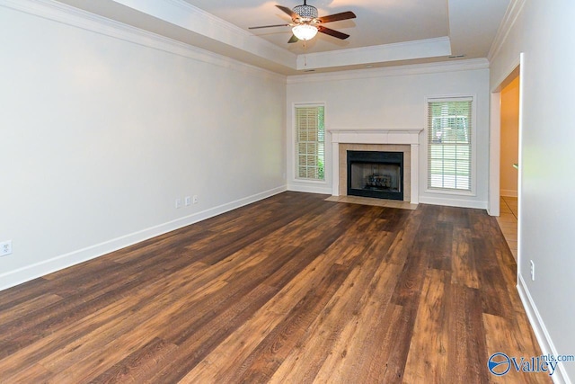 300 Honor Way, Madison, AL 35758 - unfurnished living room featuring ceiling fan, wood finished floors, a raised ceiling, crown molding, and a tiled fireplace