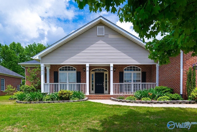 300 Honor Way, Madison, AL 35758 - view of front of home featuring brick siding, a front yard, and covered porch