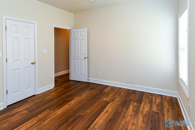 300 Honor Way, Madison, AL 35758 - unfurnished bedroom with dark wood finished floors and baseboards