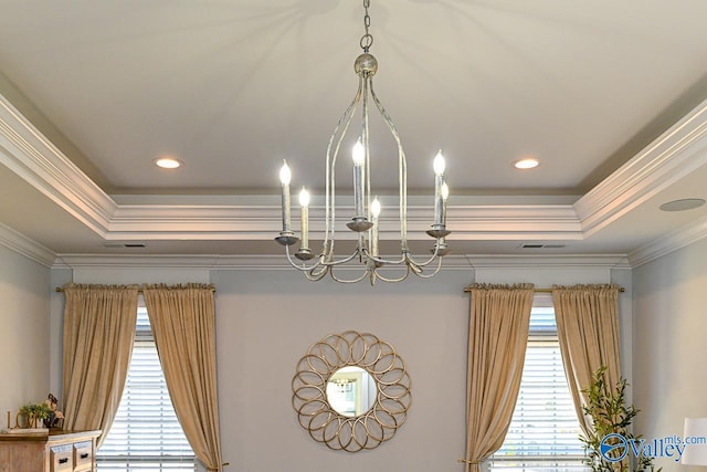 interior details with crown molding, a raised ceiling, and a chandelier