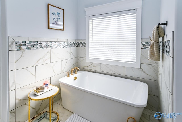 bathroom with tile walls and a bathtub