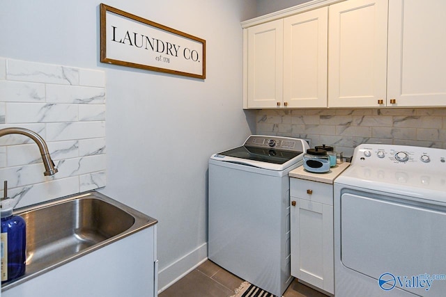 laundry room with cabinets, sink, and washer and dryer