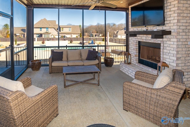 sunroom with wood ceiling, ceiling fan, and an outdoor brick fireplace