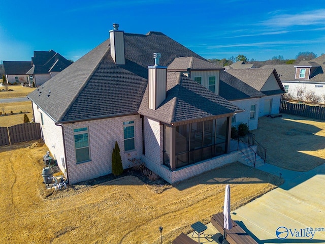 rear view of property with a yard and a patio area