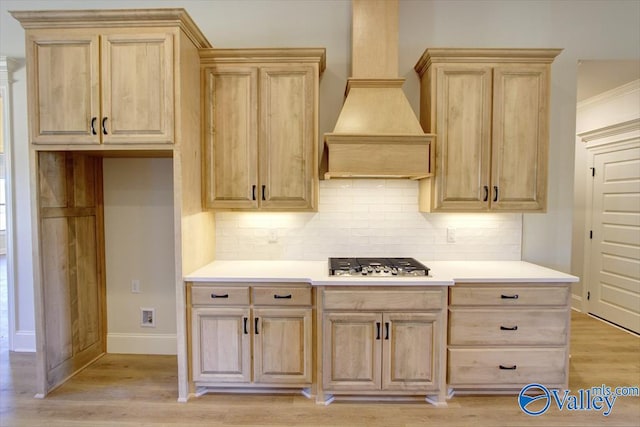 13888 Mallard Dr, Madison, AL 35756 - kitchen featuring light brown cabinets, stainless steel gas stovetop, custom range hood, and tasteful backsplash