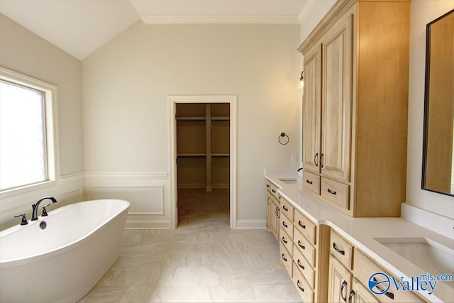 13888 Mallard Dr, Madison, AL 35756 - full bathroom with a freestanding tub, marble finish floors, double vanity, vaulted ceiling, and a walk in closet